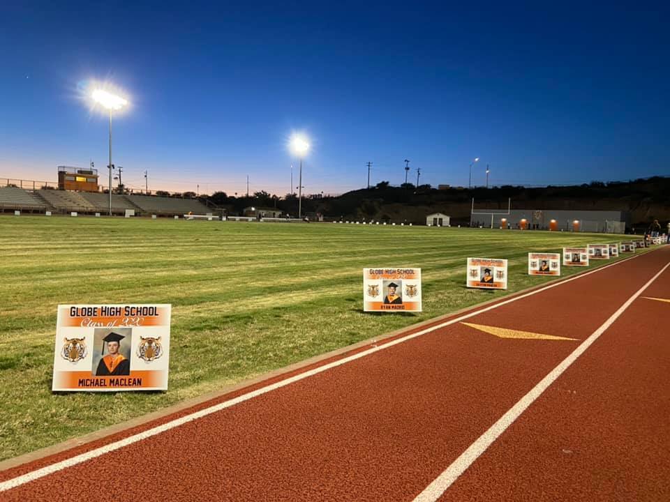 The football field is encircled with photos of graduating seniors.